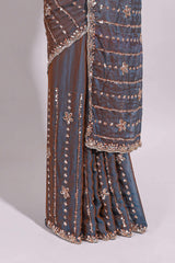Steel blue saree with silver sequin floral motifs vertical stripe detailing and an embellished border along with blouse