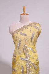 Lemon yellow saree with silver sequin abstract embroidery floral motifs and a shimmering embellished border along with matching blouse