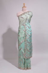 Mint green saree with silver sequin abstract wave embroidery and a detailed embellished border along with work blouse