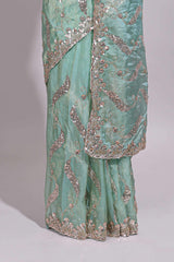 Mint green saree with silver sequin abstract wave embroidery and a detailed embellished border along with work blouse