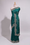 Bottle green saree with elegant golden floral embroidery and a rich embellished border along with matching blouse