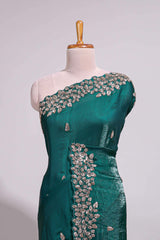 Bottle green saree with elegant golden floral embroidery and a rich embellished border along with matching blouse