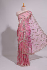 Dusty pink saree with sequin abstract wave embroidery and a detailed embellished border along with matching blouse