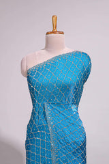 Blue saree with all over scallop pattern embroidery sequin detailing and a delicate embellished border along with matching blouse