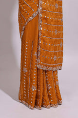 Mustard yellow saree with silver sequin vertical lines floral motifs embellished border and matching pallu design along with matching blouse