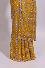 Turmeric yellow saree with silver sequin vertical lines floral motifs embellished border and matching pallu design along with matching blouse