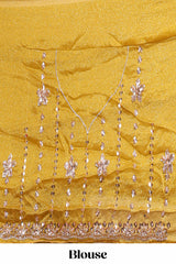 Turmeric yellow saree with silver sequin vertical lines floral motifs embellished border and matching pallu design along with matching blouse