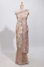 Beige floral designed tissue silk designer saree with self scallop border and matching blouse