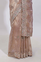 Beige floral designed tissue silk designer saree with self scallop border and matching blouse