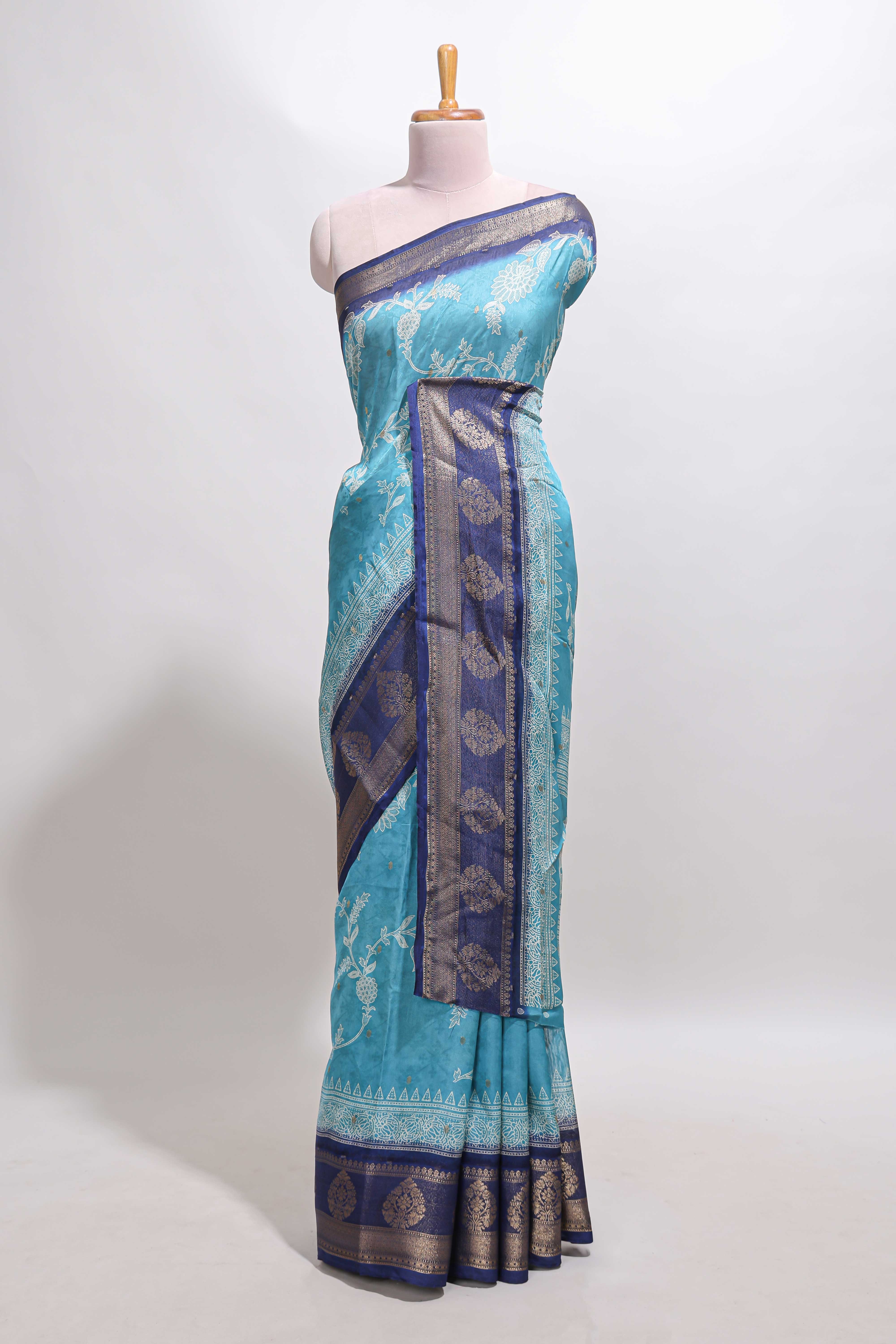 Blue floral design georgette saree with contrast border and motifs blouse