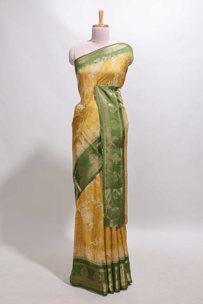 Golden yellow floral design georgette saree with contrast border and motifs blouse