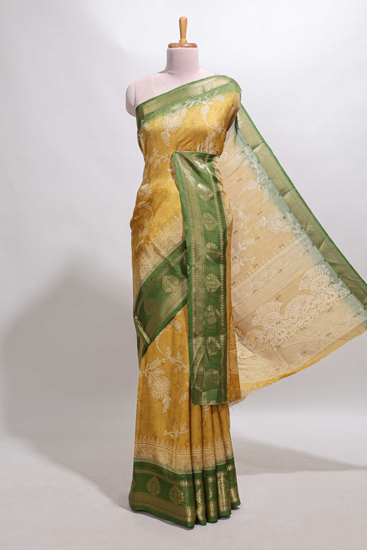 Golden yellow floral design georgette saree with contrast border and motifs blouse