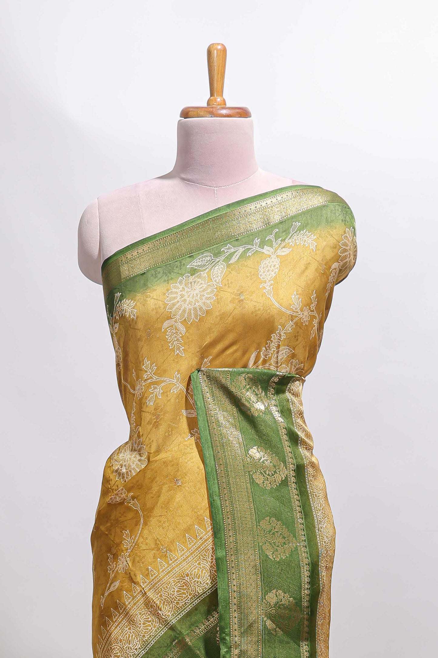 Golden yellow floral design georgette saree with contrast border and motifs blouse