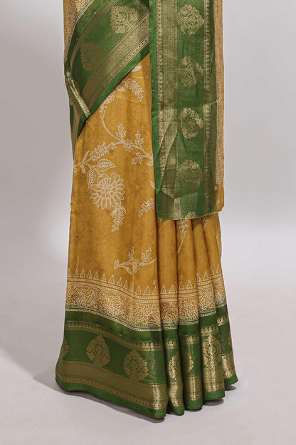 Golden yellow floral design georgette saree with contrast border and motifs blouse