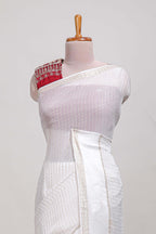 White checks georgette saree with small zari border and contrast aari work blouse
