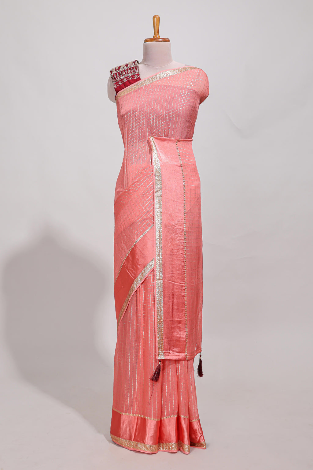 Peach zari checks georgette saree with small zari border and contrast aari work blouse
