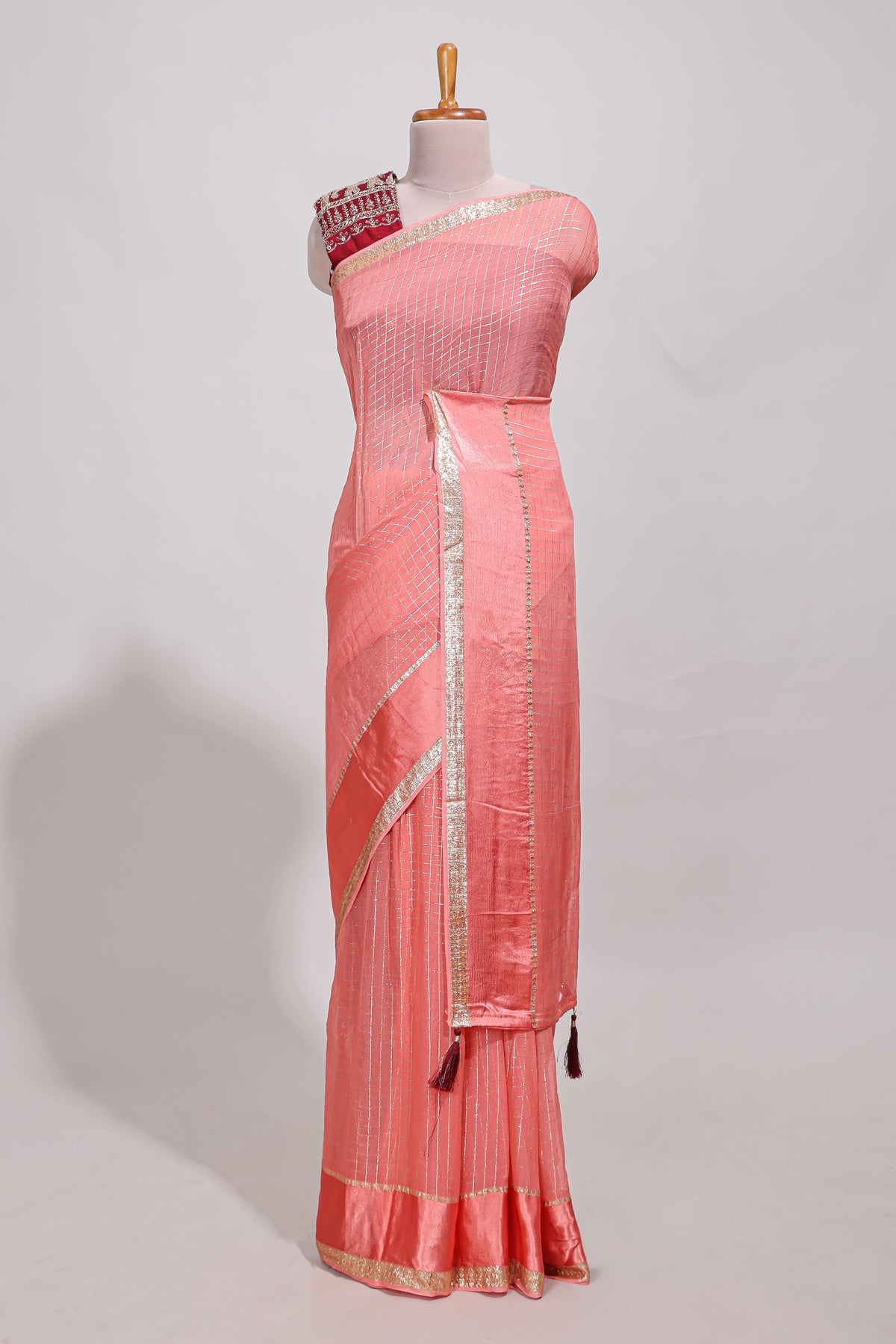 Peach zari checks georgette saree with small zari border and contrast aari work blouse