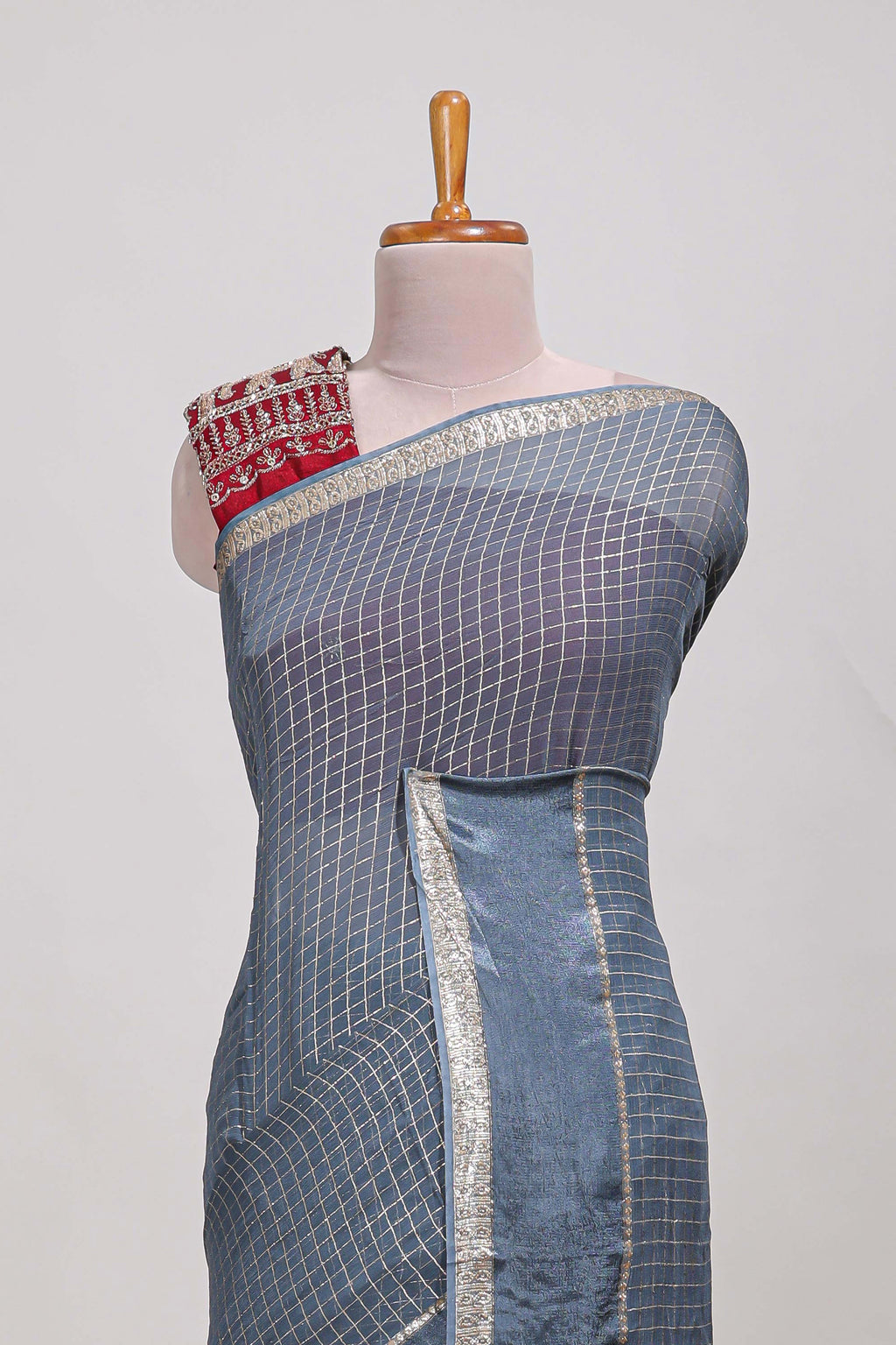 Gray zari checks georgette saree with small zari border and contrast aari work blouse