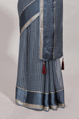 Gray zari checks georgette saree with small zari border and contrast aari work blouse