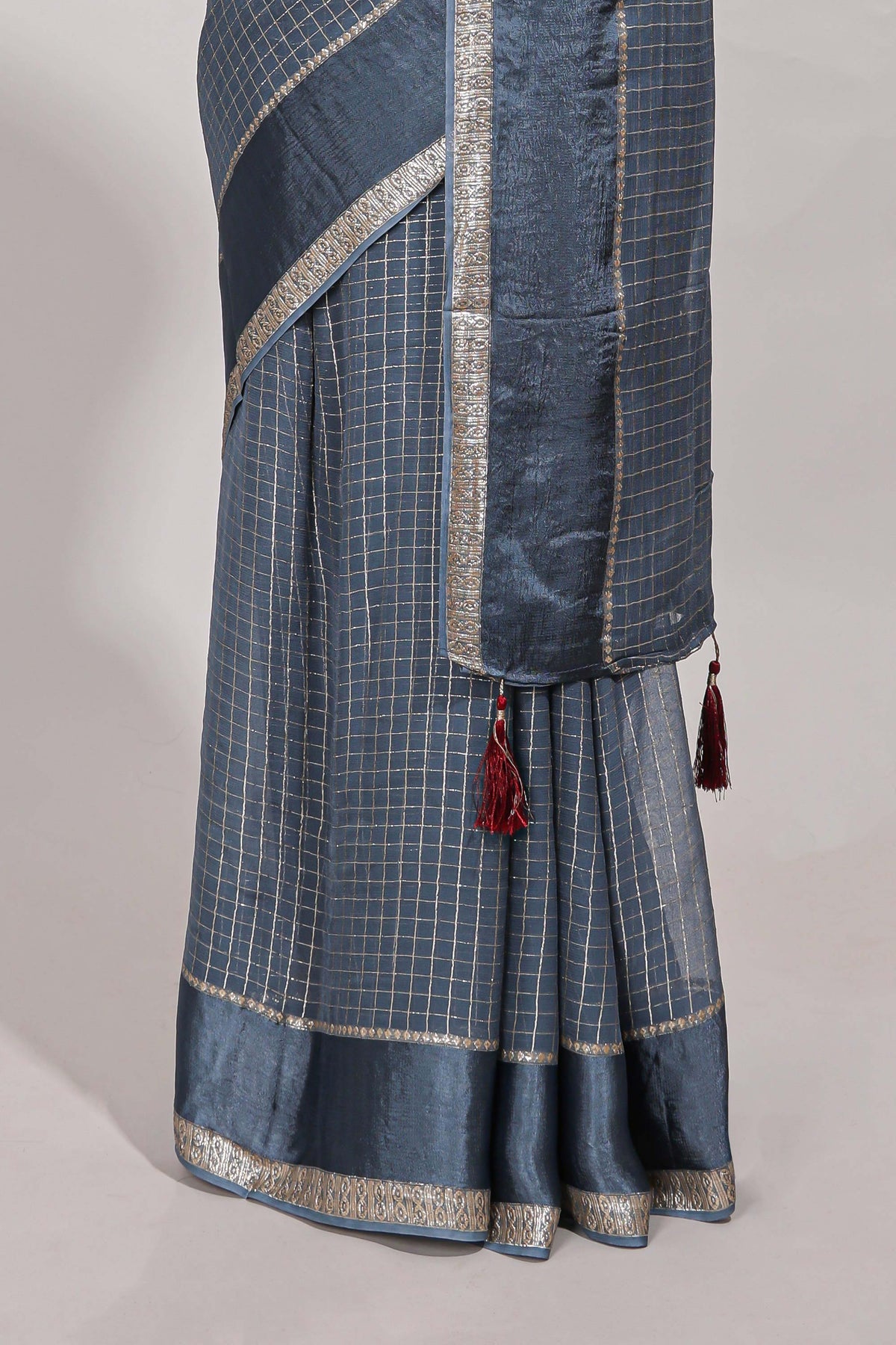 Gray zari checks georgette saree with small zari border and contrast aari work blouse
