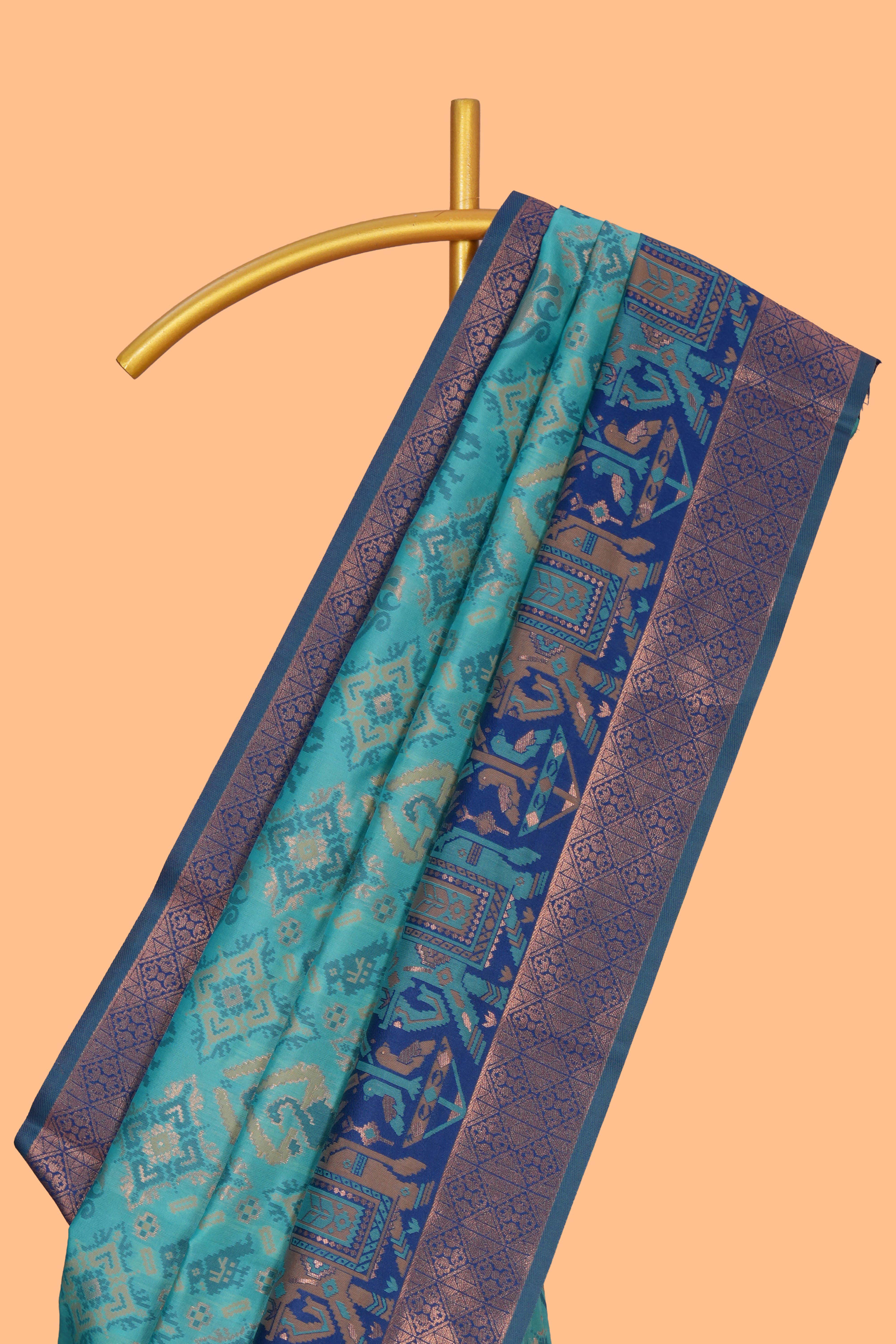 Teal green geometric & elephant motifs design ikkat cotton saree with contrast elephant design border and zari motifs blouse