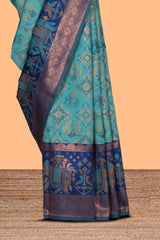 Teal green geometric & elephant motifs design ikkat cotton saree with contrast elephant design border and zari motifs blouse