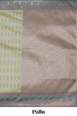Green geometric motifs design ikkat cotton saree with contrast zari design border and zari floral motifs blouse