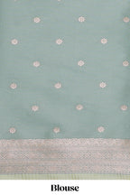 Green geometric motifs design ikkat cotton saree with contrast zari design border and zari floral motifs blouse