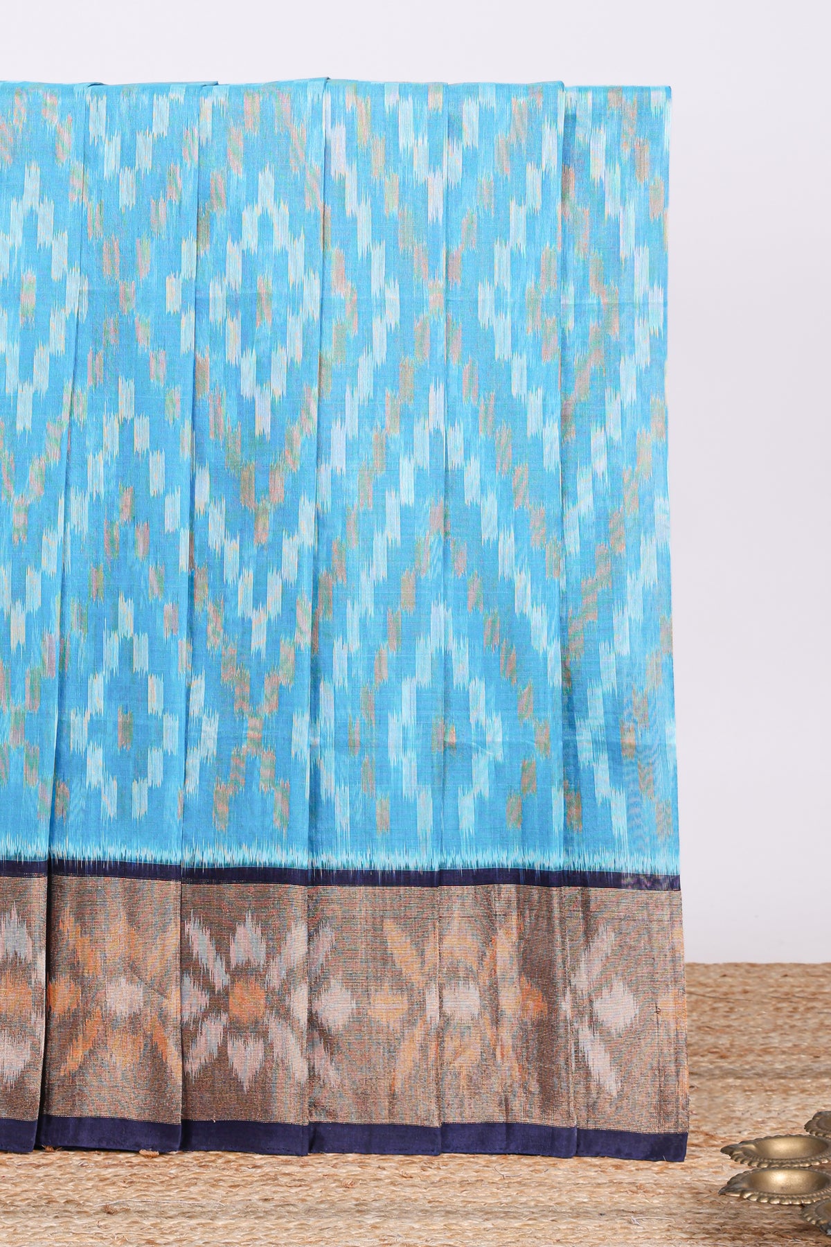 Blue ikkat design cotton saree with contrast zari border and plain blouse