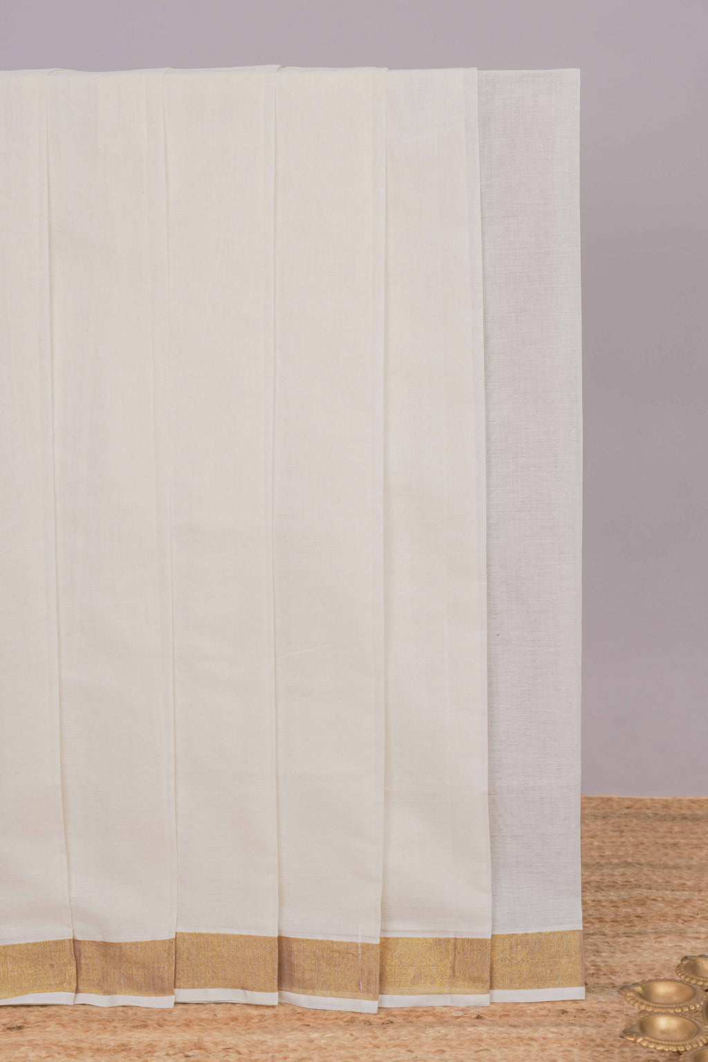 Cream plain design kerala cotton saree with self zari border and peacock design pallu