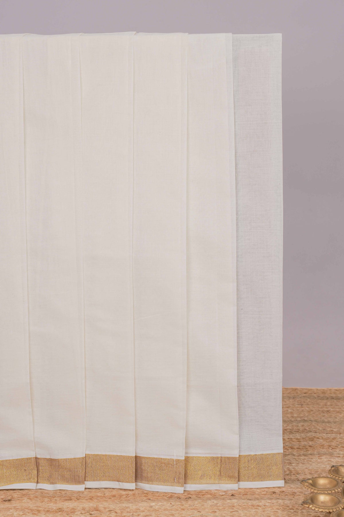 Cream plain design kerala cotton saree with self zari border and peacock design pallu