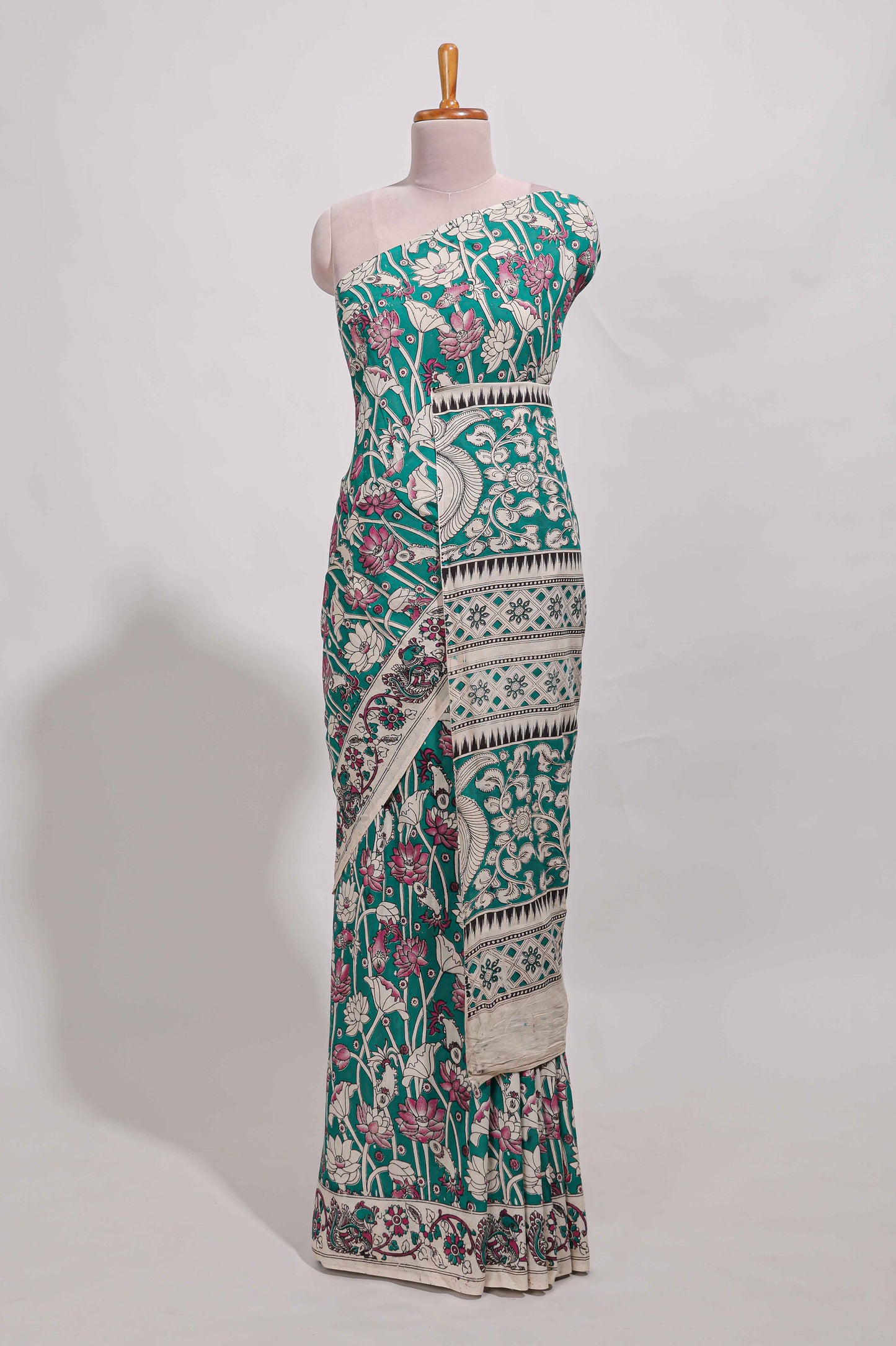 Green kalamkari printed cotton saree with traditional floral motifs and contrast pallu