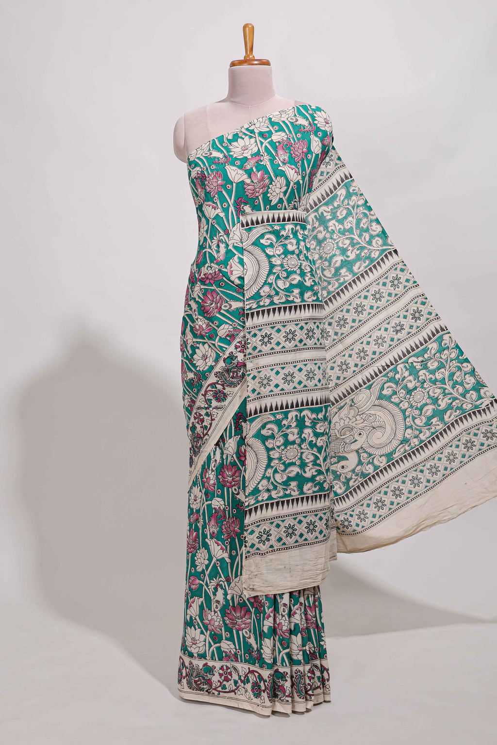 Green kalamkari printed cotton saree with traditional floral motifs and contrast pallu