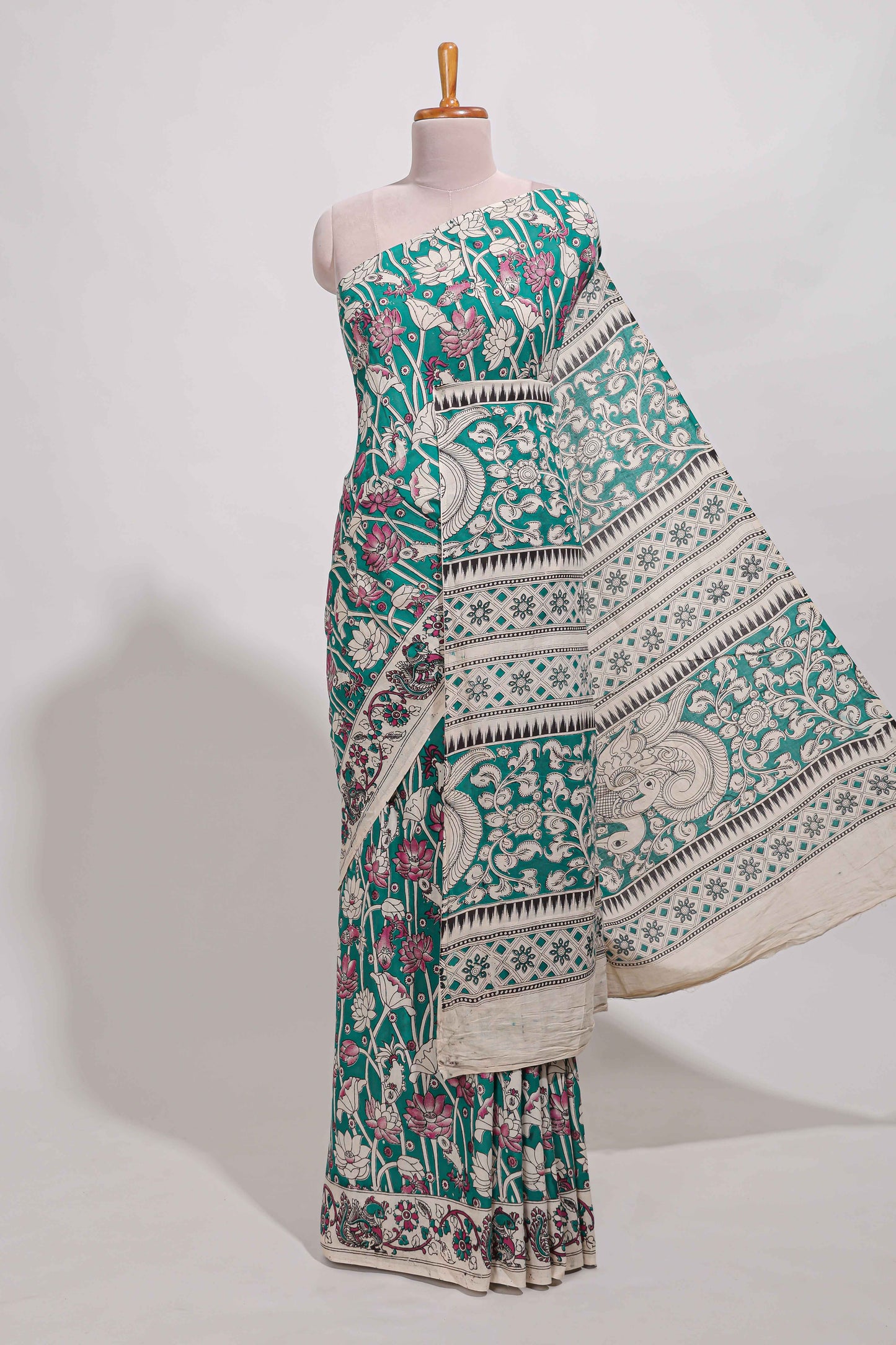 Green kalamkari printed cotton saree with traditional floral motifs and contrast pallu