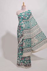 Green kalamkari printed cotton saree with traditional floral motifs and contrast pallu