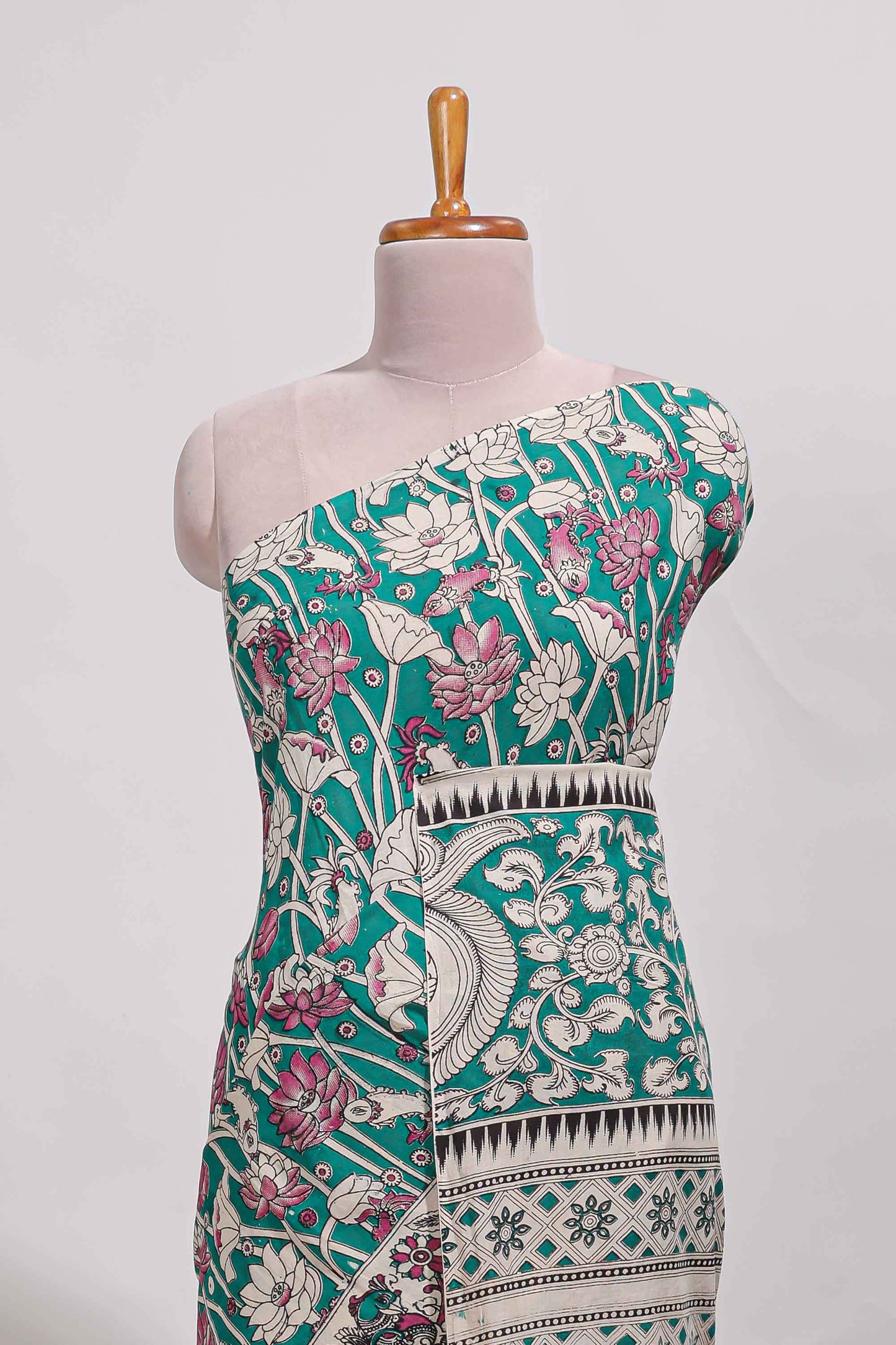 Green kalamkari printed cotton saree with traditional floral motifs and contrast pallu