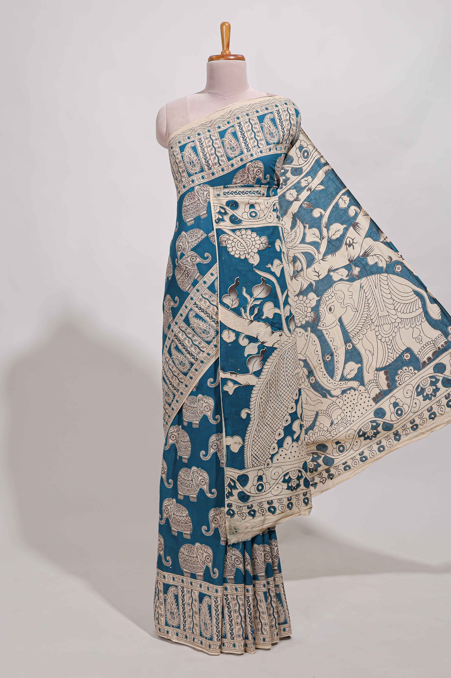 Blue kalamkari printed cotton saree with traditional floral motifs and contrast pallu