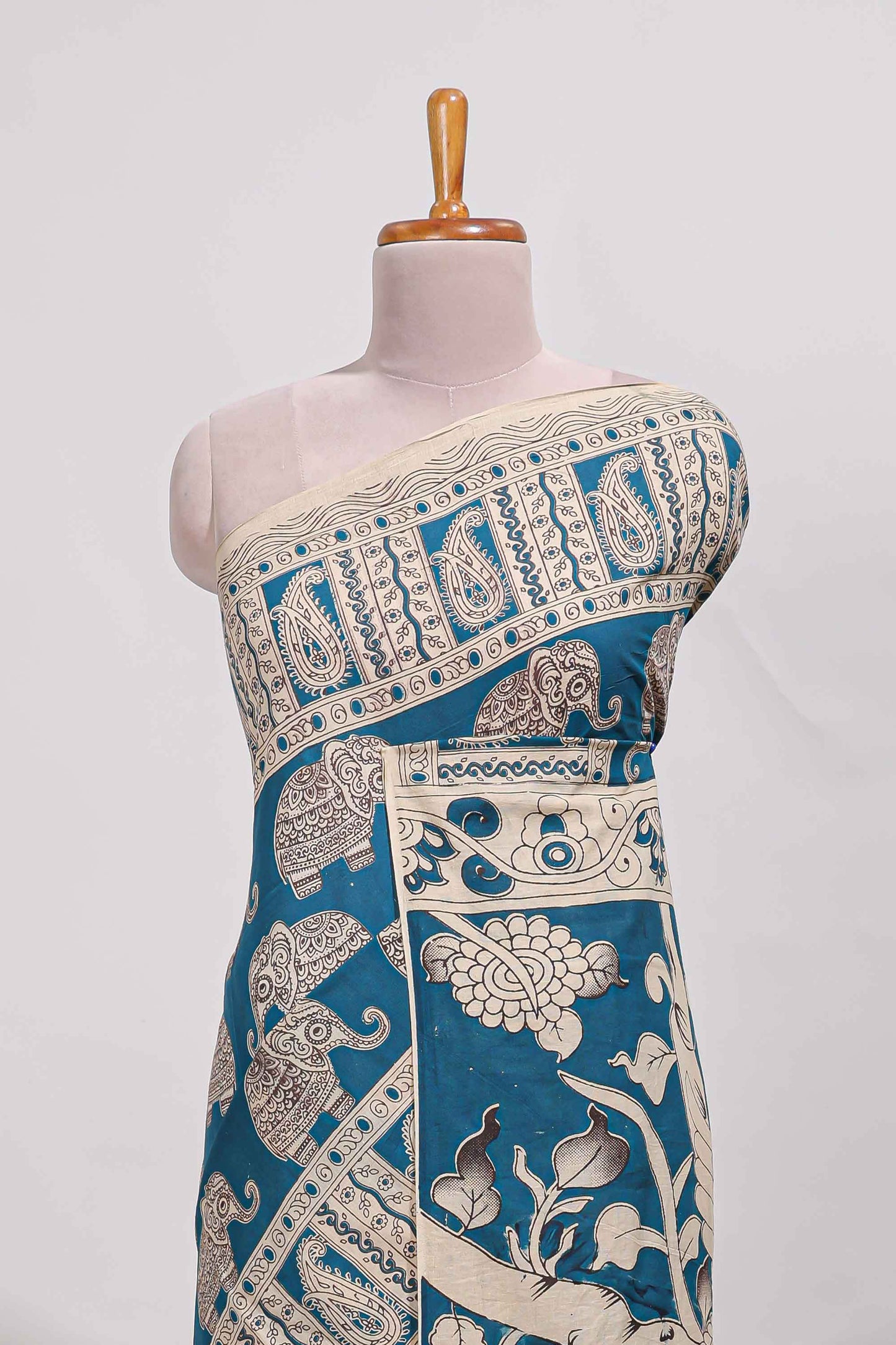 Blue kalamkari printed cotton saree with traditional floral motifs and contrast pallu