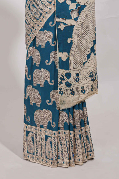 Blue kalamkari printed cotton saree with traditional floral motifs and contrast pallu