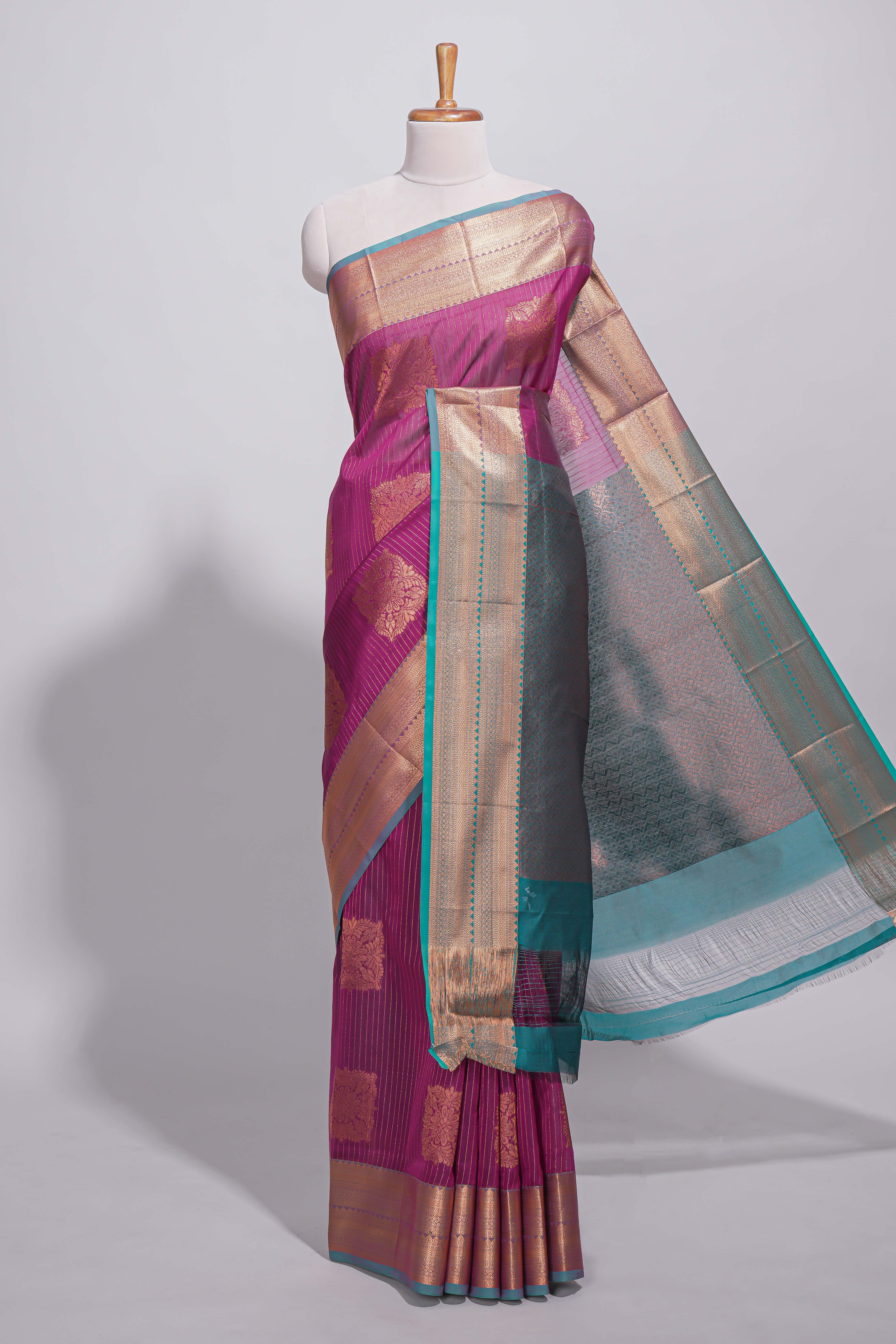 Rich magenta tussar saree with gold zari floral buttas teal zari border and woven zari pallu with contrast blouse piece