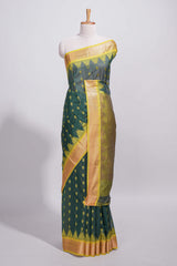 Dark teal green kotta cotton with gold zari buttas a zari border with temple design and zari woven pallu with matching blouse piece