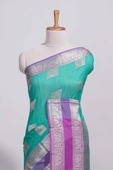 Rama green tussar saree with silver zari square buttas retta petta zari border and woven zari pallu with contrast blouse piece