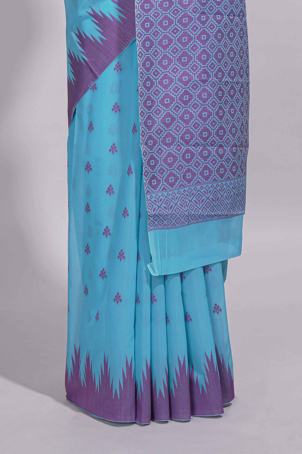 Sky blue Kotta cotton saree with woven buttas contrasting purple Ikat-inspired border and a geometric woven pallu with matching blouse