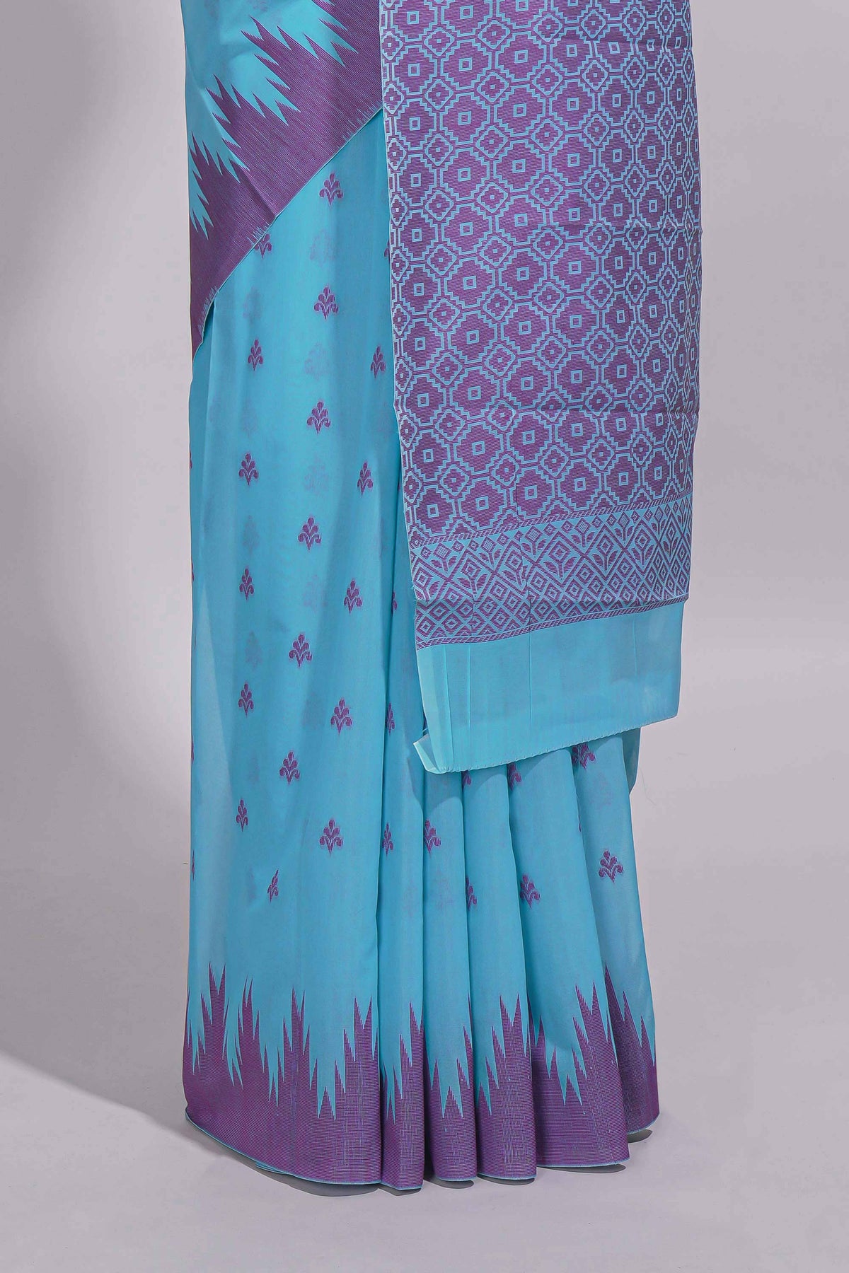 Sky blue Kotta cotton saree with woven buttas contrasting purple Ikat-inspired border and a geometric woven pallu with matching blouse