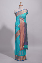 Blue tussar saree with gold zari floral buttas teal zari border and woven zari pallu with contrast blouse piece