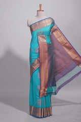 Blue tussar saree with gold zari floral buttas teal zari border and woven zari pallu with contrast blouse piece