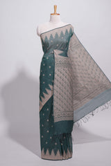 Dark green kotta cotton saee with gold zari buttas a zari border with temple design and zari woven pallu with matching blouse piece