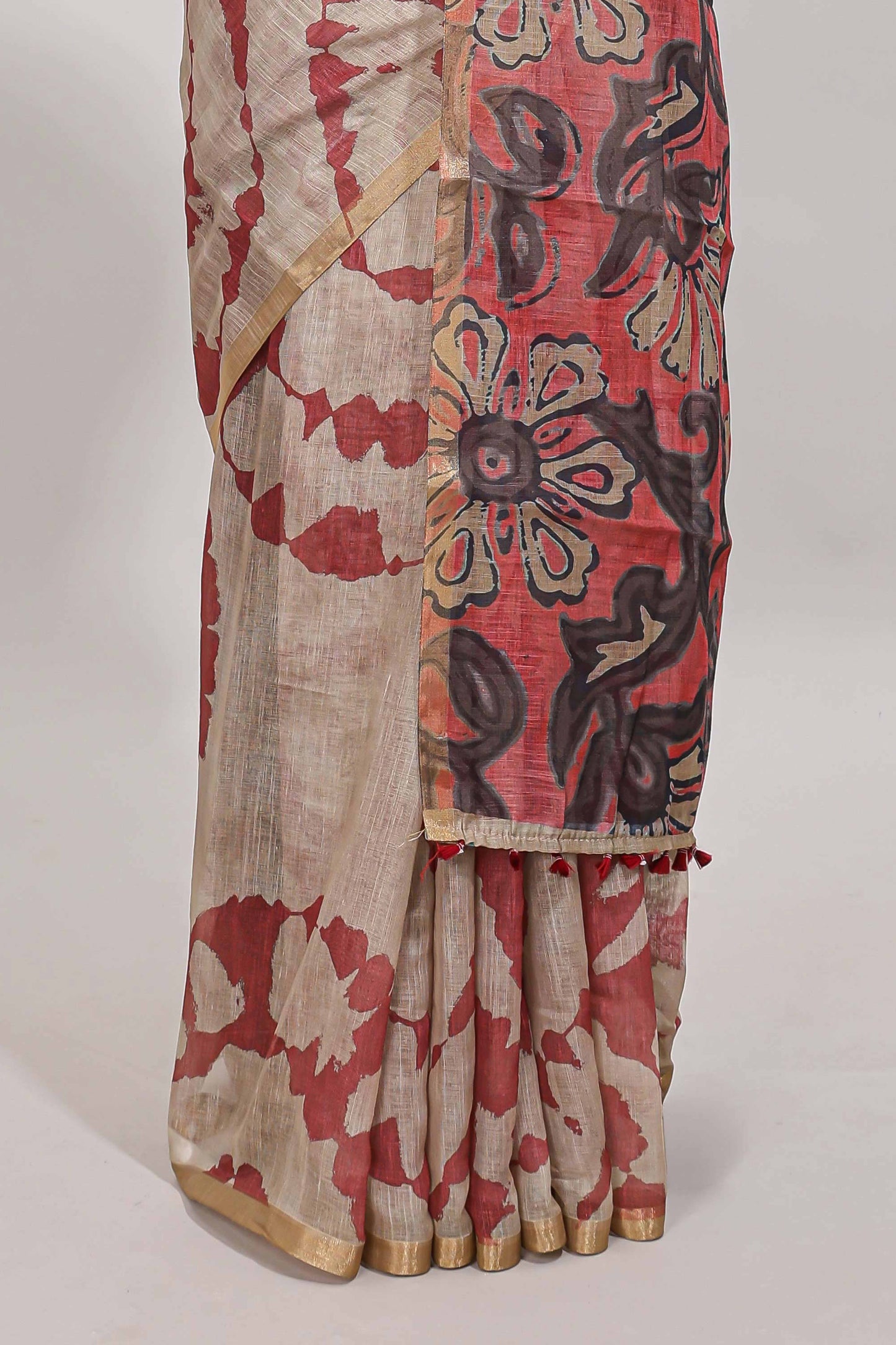 Beige linen cotton saree with red shibori print, self zari border and floral design pallu