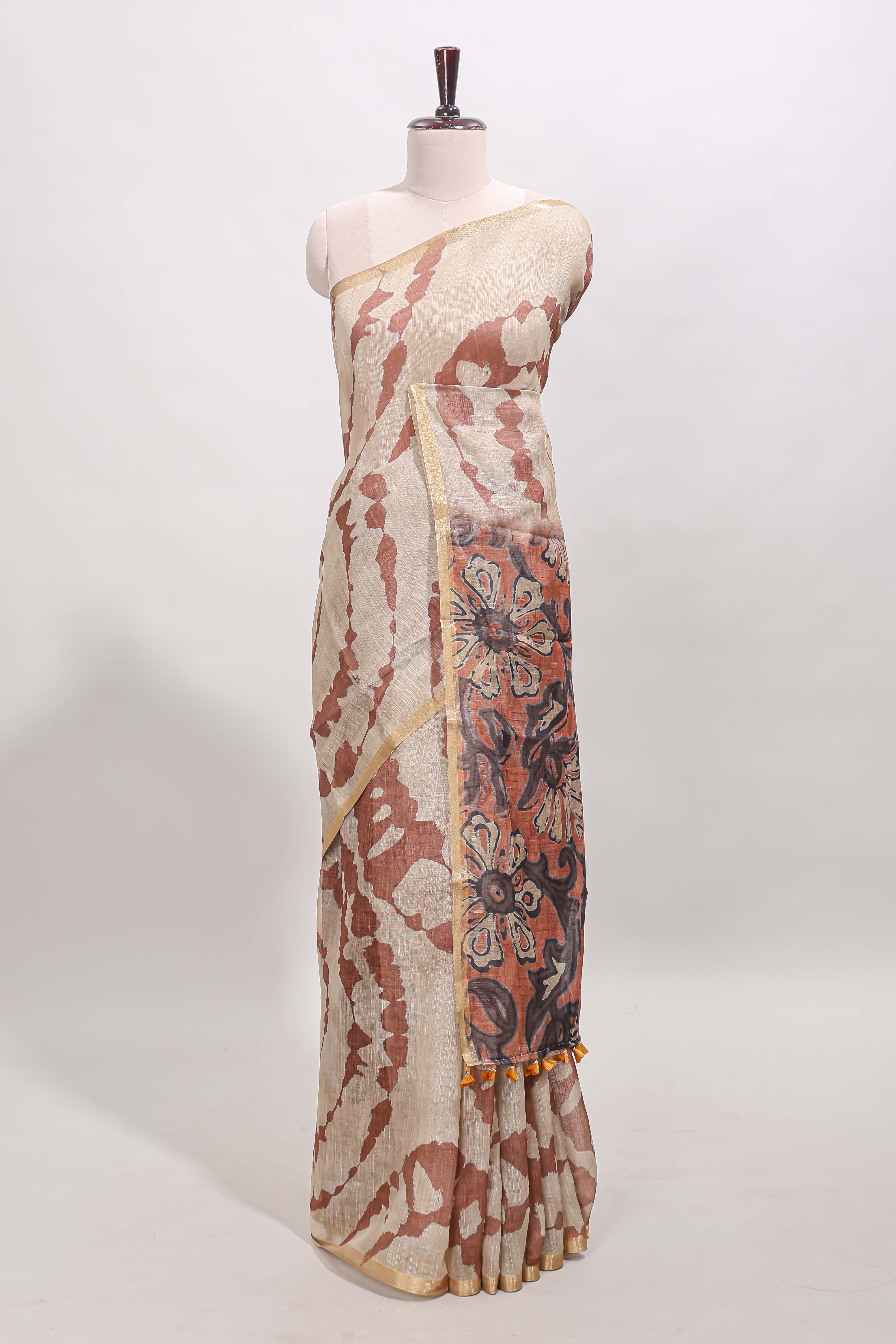 Beige linen cotton saree with brown shibori print, self zari border and floral design pallu