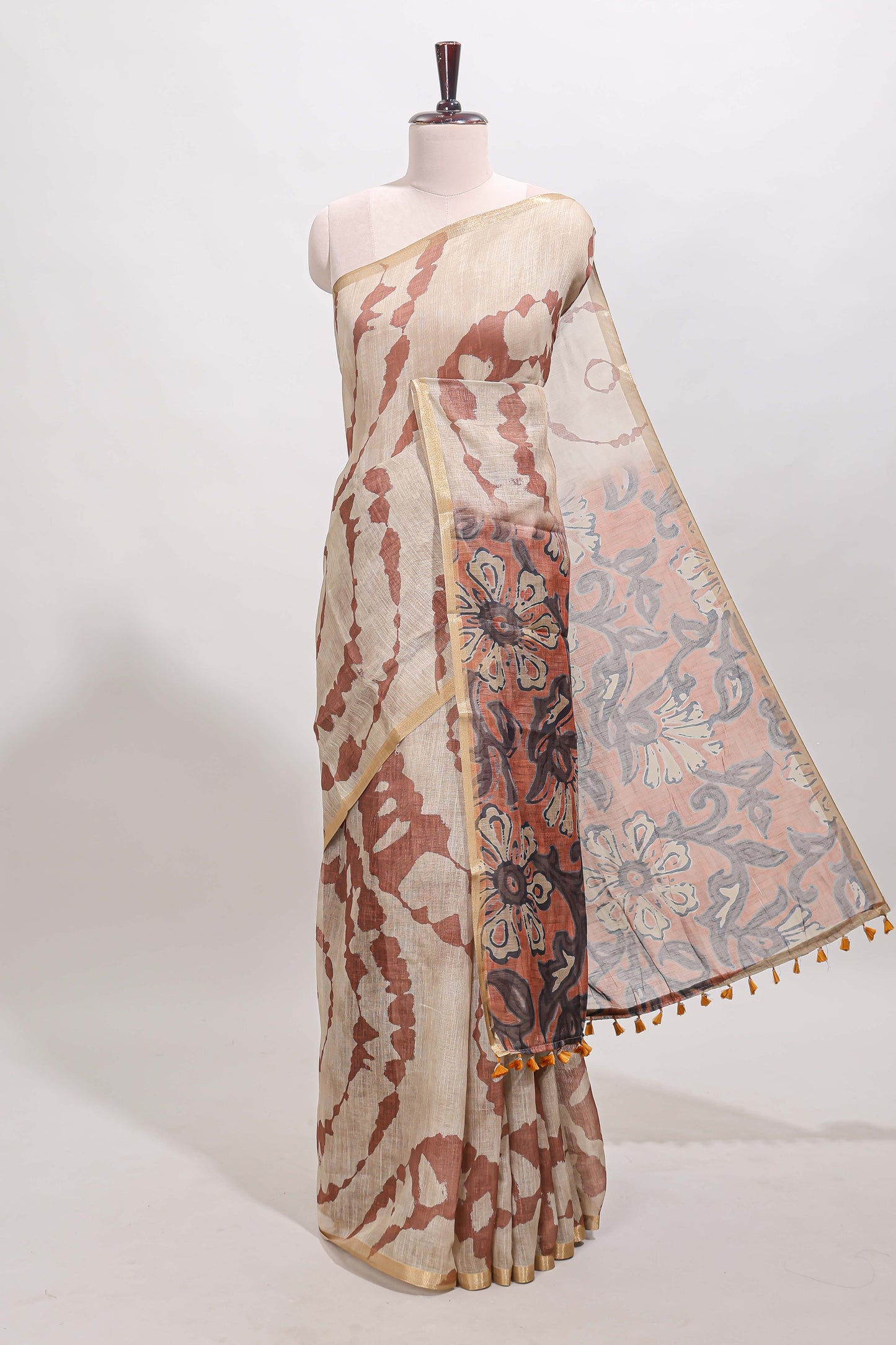 Beige linen cotton saree with brown shibori print, self zari border and floral design pallu